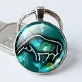 Zodiac sign metal keychain with green glass cabochon featuring white abstract bull pattern - Cyan Rhino Lines (7)