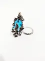 Detail of vintage silver ring featuring a large sky blue crystal and butterfly motifs - US 8 / Aqua