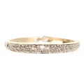 Detail shot of the gold plated open bangle with pavé set sparkling white crystals - Gold + White