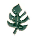 Detailed view of monstera leaf brooch featuring gold trim and green enamel finish - Monstera Leaf