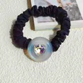 Detail of black pleated scrunchie with iridescent pearl button and heart crystal - White Heart Style