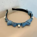 Light blue denim headband with bow accents and white pearls on a minimalist background - Light Blue Pearl
