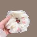 Detail of off-white mesh scrunchie with pink floral inserts and pleated texture - Off White