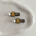 Cute golden bear hair clips with black ribbon, white pearl, and LOVEDAYS engraving - Bear Heart Hairpin