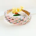 Detail shot of a wide woven tweed headband in sweet pastel pink and blue colors - Pink Grid