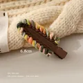 Detailed view of a 6.8cm colorful knitted wool hair clip for girls with rainbow trim - Brown