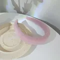 Padded light pink lace headband with elegant texture on a cream ceramic plate - Pink Purple