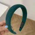 Thick velvet headband in emerald green featuring a hand made woven label detail - Dark Green