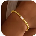 Minimalist gold beaded bracelet featuring a rectangular clear zircon stone on wrist - 14k / Gold April (White)