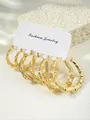Close-up of three pairs of bamboo-textured gold hoop earrings on a fashion display card - 14k / Gold (3 Pairs Pack) (e1806)