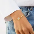 Elegant 14K gold plated four-leaf clover bracelet with sparkling crystals on model - 14k / Silver