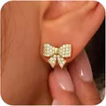 Exquisite gold bow-knot earrings with pavé crystals on a woman's earlobe - Fine Pave Zirconia Bowknot Style (e1798) / 14k / One Pair / Gold