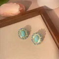 Close-up of vintage gold plated brass studs featuring oval turquoise stones and bead trim - Oval Style (e005)