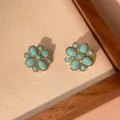 Detailed macro view of vintage turquoise flower stud earrings in gold-plated brass base - Oval Four-Petal Flower (e005)