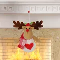 Plush Christmas reindeer ornament with red scarf and heart detail hanging on a fireplace - Reindeer Style