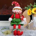 Christmas plush elf doll with red and green outfit and hat sitting on a gift box - Male Christmas Elf (Long Legged)