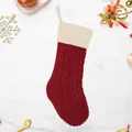 Calza natalizia a trecce rosso scuro con polsino bianco su sfondo di marmo - Calza in maglia patchwork rossa