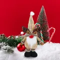Rudolph reindeer gnome plush doll with gold sequined hat and brown antlers on red backdrop - Christmas Reindeer Telescopic Doll