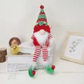 Christmas gnome plush with long striped legs and red green knit hat on white books - Christmas Elf Long Leg Doll
