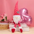 Pink heart plush Valentine gnome with polka dot hat and dangling legs on white books - Red