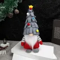 Christmas gnome plush with grey tiered tree hat and red body on a white stage - Gray Christmas Tree Hat Sitting Gnome