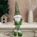 Long-legged Christmas gnome plush in forest green with red knitted hat on fireplace - Green Long Legs (5809271132605) / Green