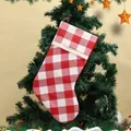 Red and white buffalo plaid Christmas stocking with knitted cuff hanging on a tree - Red And White Plaid Christmas Stocking