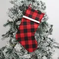 Classic red and black buffalo plaid Christmas stocking with white ribbed cuff hanging on tree - Red and Black Buffalo Plaid