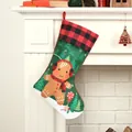 Festive Christmas stocking with gingerbread man and red plaid cuff on white fireplace - Gingerbread Man in Christmas Stocking