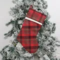 Classic red and black plaid Christmas stocking with white trim hanging on tree - Red and Green Tartan Plaid