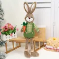 Brown long-legged plush Easter bunny in green plaid outfit holding a bright carrot - Green Long Leg Rabbit / Green