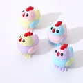 Detail of four colorful cartoon chicken pencil sharpeners in pastel pink, blue, and yellow - Mixed Random