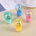 Cute bulb-shaped pencil sharpeners in four pastel colors with cartoon emoji expressions - Random Colors