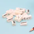 Group of white single-hole pencil sharpeners with steel blades on blue background - White