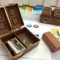 Chocolate-shaped pencil sharpener set in dark brown with a matching eraser accessory - Chocolate