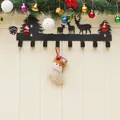 Black metal Christmas wall hook with reindeer silhouettes and beige stockings decoration - Santa Claus