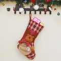 Christmas stocking with 3D reindeer and plaid patterns hanging on a decorated festive wall - Elk Style