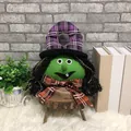 Halloween witch plush doll decoration with green face and purple checkered hat on wood stand - Witch