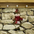 Christmas snowman plush ornament in red plaid outfit hanging on a wooden hook - Snowman