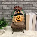Halloween burlap gift bag with pumpkin and witch hat on a rustic wooden stand - Pumpkin Style