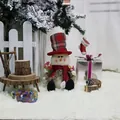 Sitting Christmas snowman doll with red plaid hat and scarf for holiday home decor - Snowman