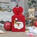 Red non-woven Christmas gift bag with 3D Santa Claus and heart-shaped handle - Santa Claus