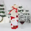 Christmas burlap wine bottle cover featuring Santa Claus applique and red ribbon - Santa Claus