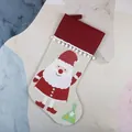 Beige Christmas stocking with Santa Claus motif and red cuff for holiday gifts - Santa Claus