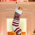 Knitted Christmas stocking with red reindeer pattern and stripes for festive gift hanging - Elk