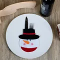 Christmas snowman cutlery holder pouch on white plate for festive dining table decoration - Black Hat Snowman