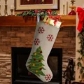 Cream linen Christmas stocking with green tree and snowflakes hanging on fireplace - Christmas Tree