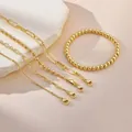 Set of 5 gold-plated brass chain bracelets with lobster clasps and beaded elastic band - Five-Piece Set / Gold