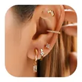 Gros plan détaillé d'un ensemble de boucles d'oreilles en laiton doré avec zircons et bagues - Style Or Pendentif Transparent (e447) / 1 Pièce