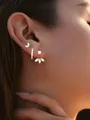 Detailed view of three-piece gold plated brass earrings set with zircons on model ear - 3-Piece Earring Set (e887) / 14k / Gold